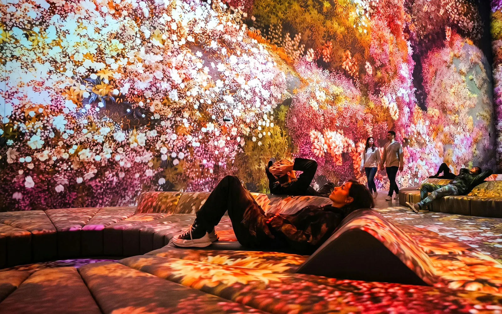 Visitors relaxing in the immersive Flower Room at Mercer Labs Museum of Art.