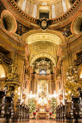 Baroque interior of St. Peter's Church in Vienna with ornate altar and gilded decorations.