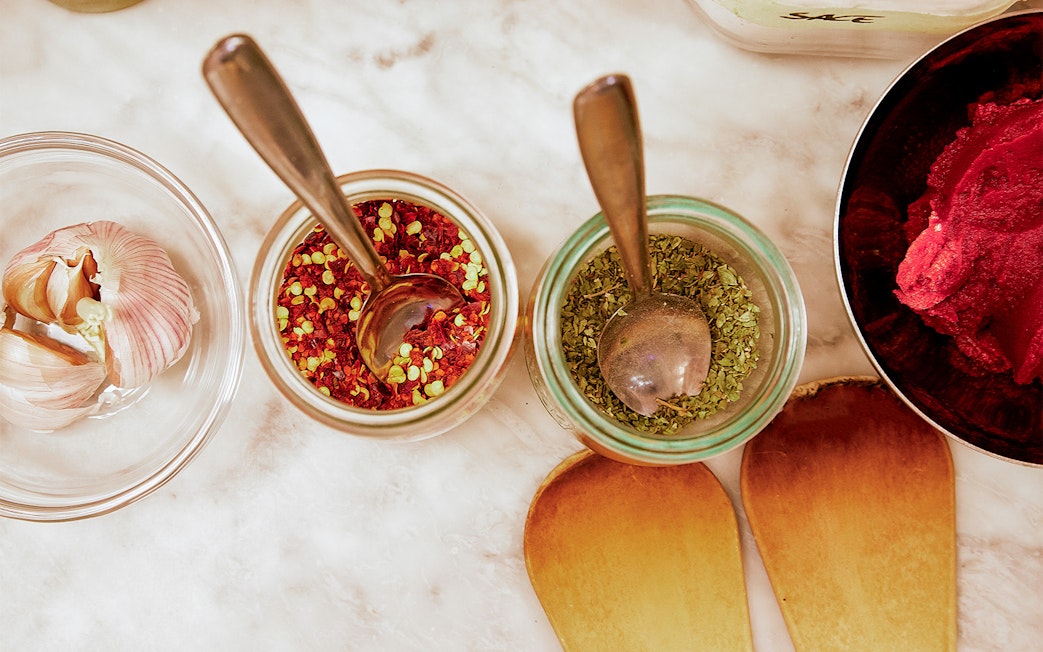 Garlic, spices, and herbs on a table for a Florence cooking class.