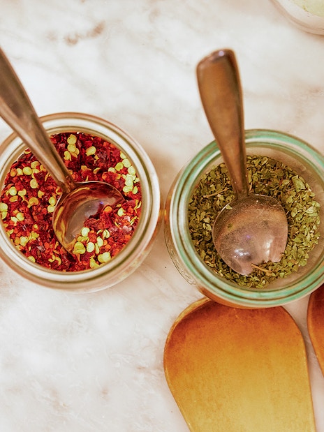 Garlic, spices, and herbs on a table for a Florence cooking class.