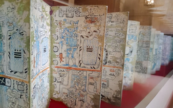 Ancient manuscript with intricate drawings at a museum in Santo Domingo.