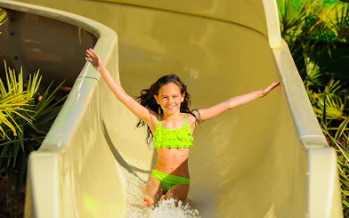 Child enjoying a water slide at Zoomarine Portugal.