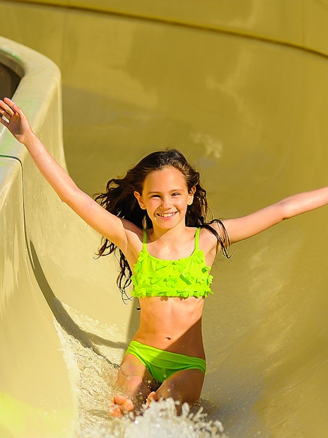 Child enjoying a water slide at Zoomarine Portugal.