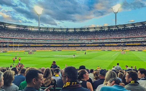 Australian Rules football match at Melbourne Cricket Ground with a large crowd.
