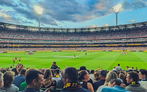 Australian Rules football match at Melbourne Cricket Ground with a large crowd.