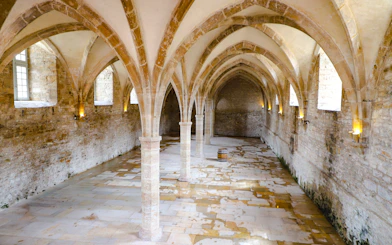 Vaulted stone hall inside Cluny Abbey, Lyon, France.