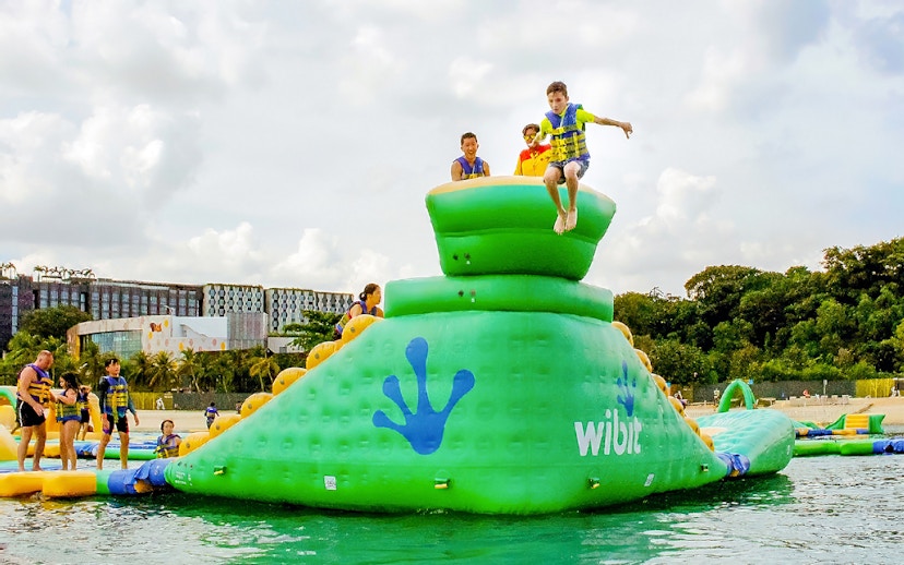 Participants enjoying inflatable obstacle course at HydroDash Singapore.
