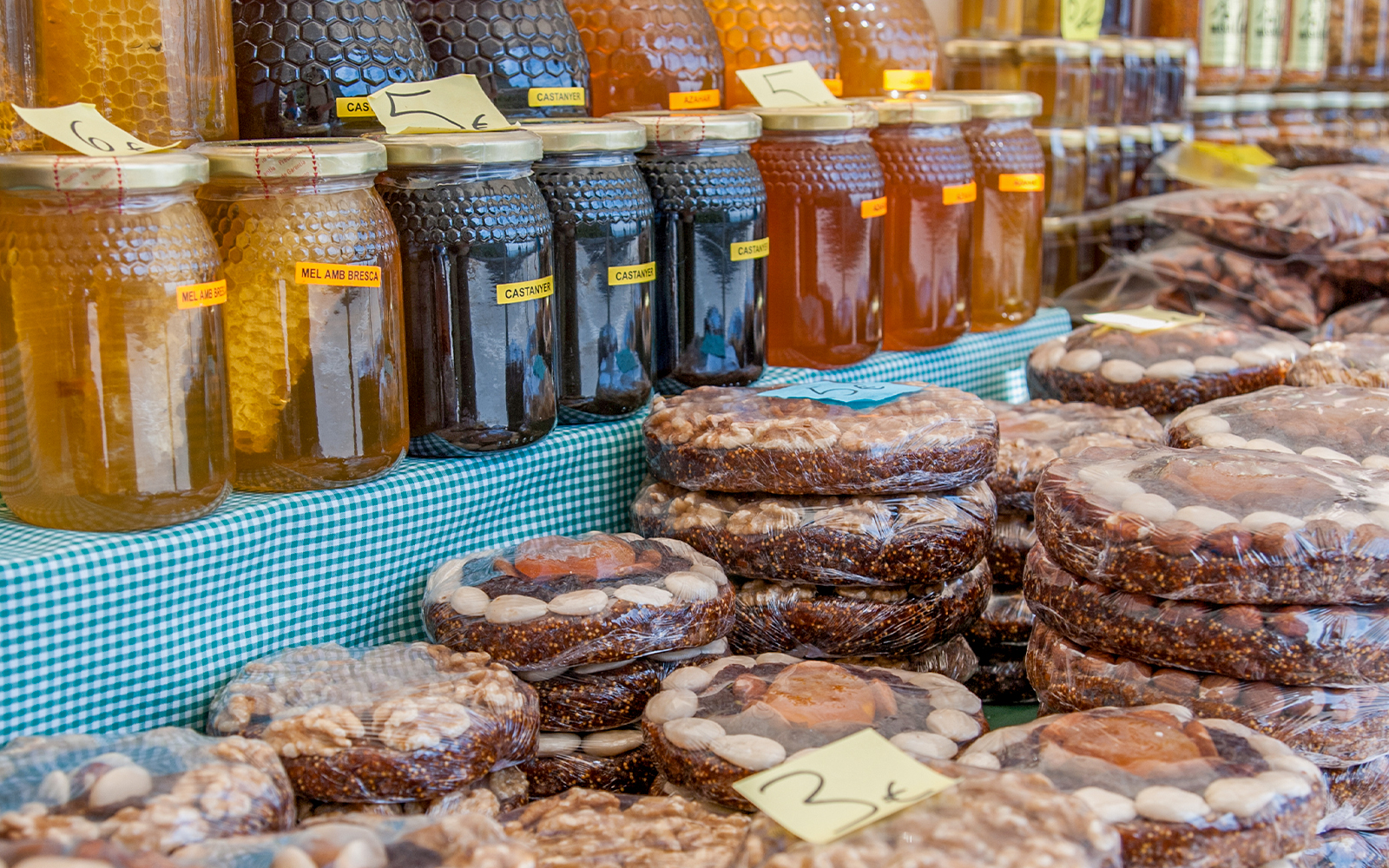 Jars of honey and packaged nut cakes at a Montserrat street market.