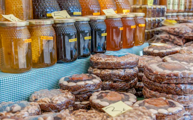 Jars of honey and packaged nut cakes at a Montserrat street market.