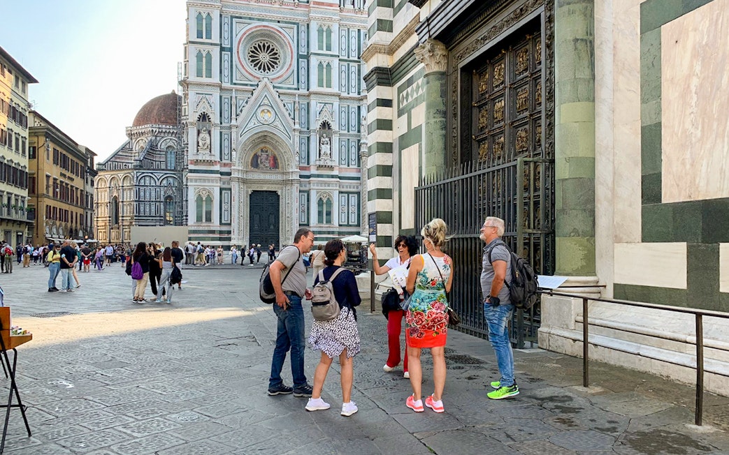 Tourists with guide near Florence Duomo, Italy.