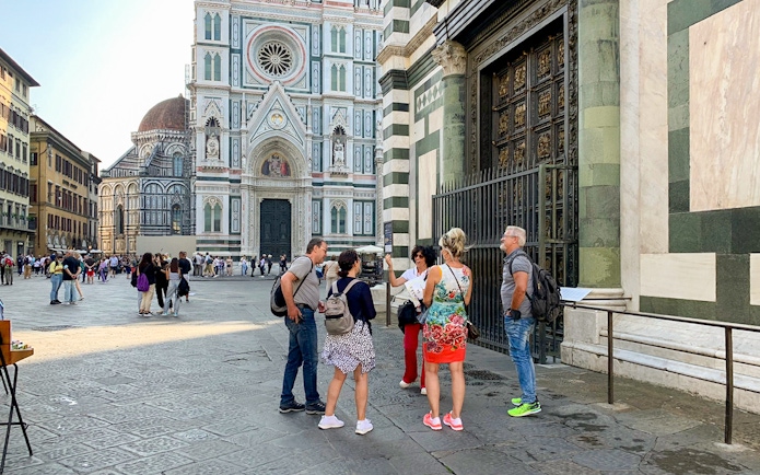 Tourists with guide near Florence Duomo, Italy.