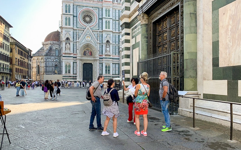 Tourists with guide near Florence Duomo, Italy.