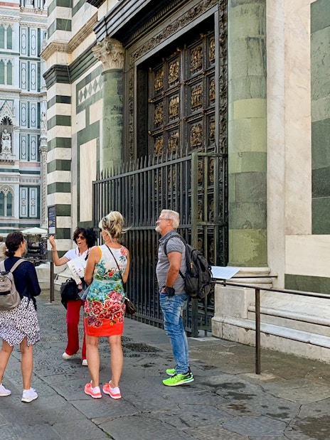 Tourists with guide near Florence Duomo, Italy.