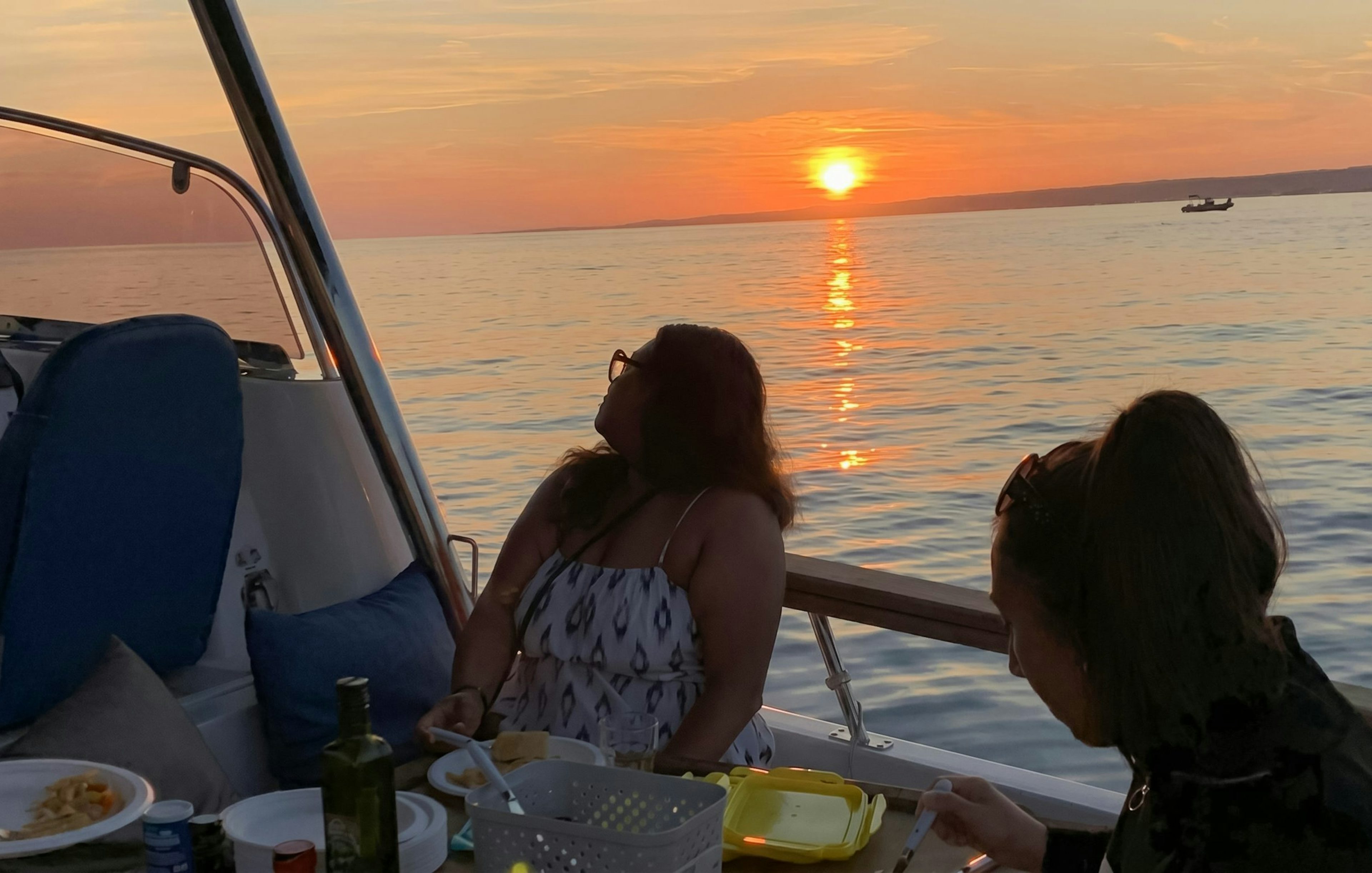 Dinner cruise on a boat in Marseille with sunset view over the sea.