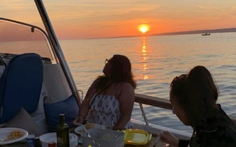 Dinner cruise on a boat in Marseille with sunset view over the sea.
