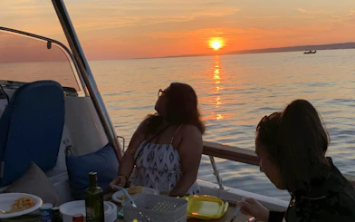 Dinner cruise on a boat in Marseille with sunset view over the sea.