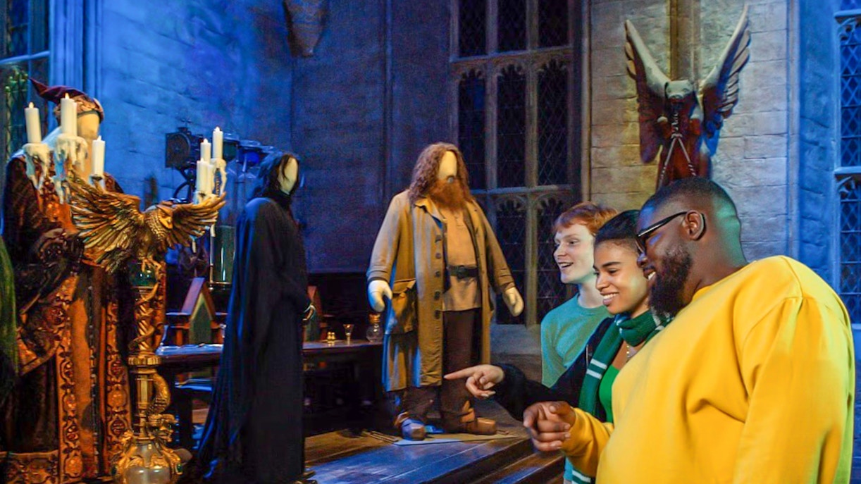 Visitors at Harry Potter Warner Bros. Studio Tour viewing character costumes.