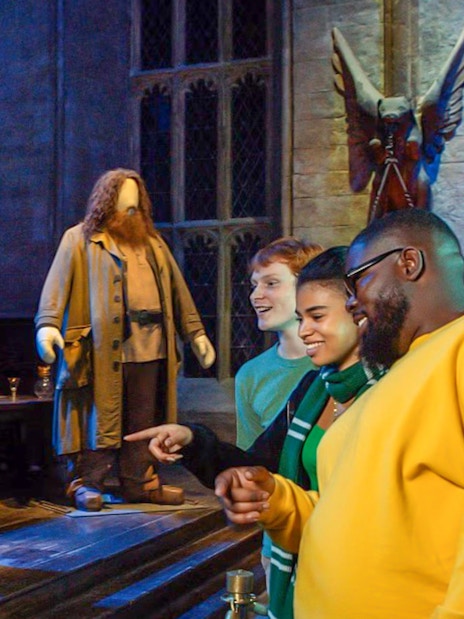 Visitors at Harry Potter Warner Bros. Studio Tour viewing character costumes.