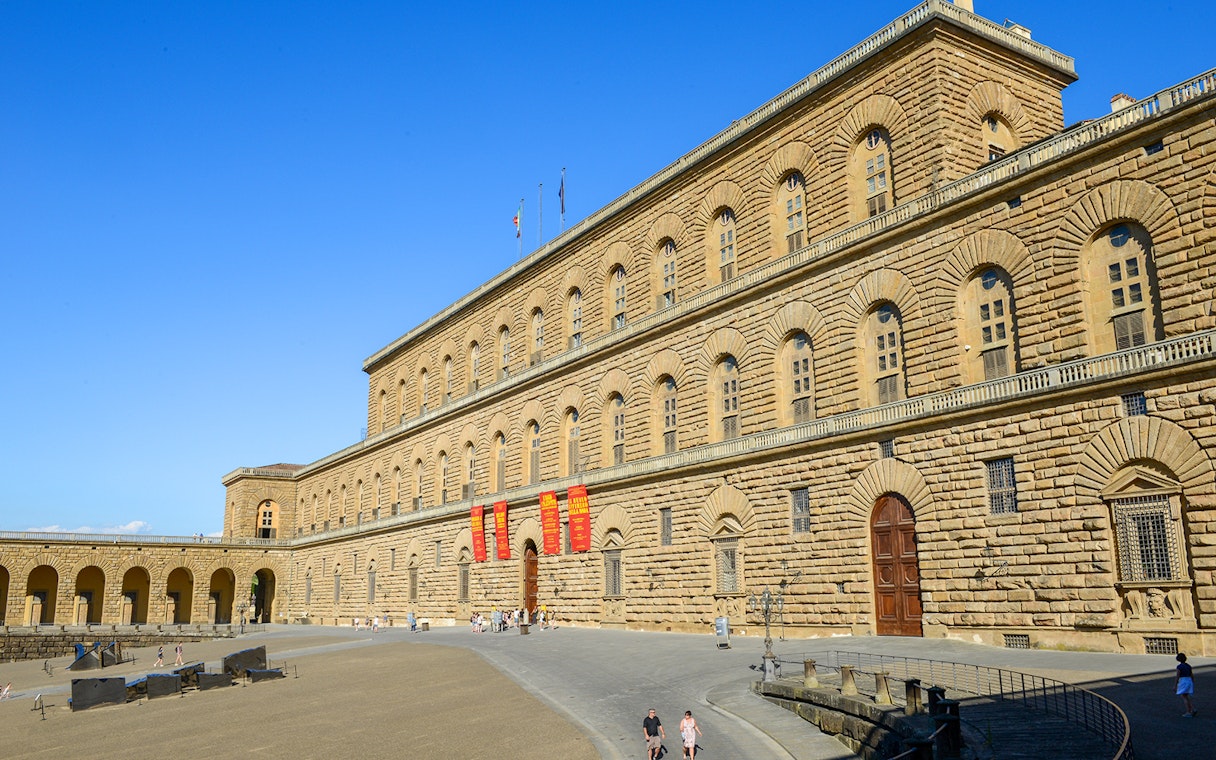 Pitti Palace exterior with visitors, Florence, Italy.