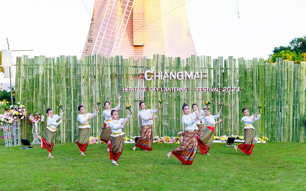 Thai dancers performing traditional dance in colorful attire at Chiang Mai Sky Lanterns Festival.