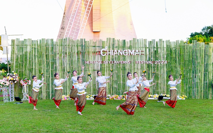 Thai dancers performing traditional dance in colorful attire at Chiang Mai Sky Lanterns Festival.