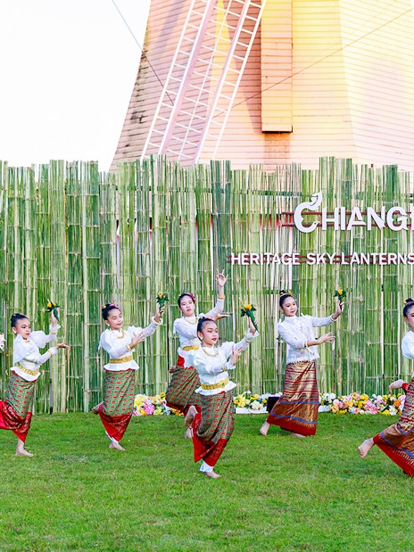 Thai dancers performing traditional dance in colorful attire at Chiang Mai Sky Lanterns Festival.