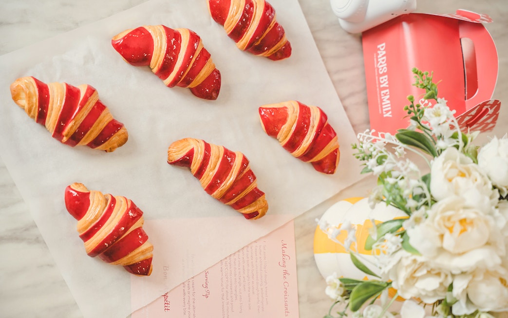 Red-striped croissants on parchment paper from Emily in Paris Croissant-Making Workshop.
