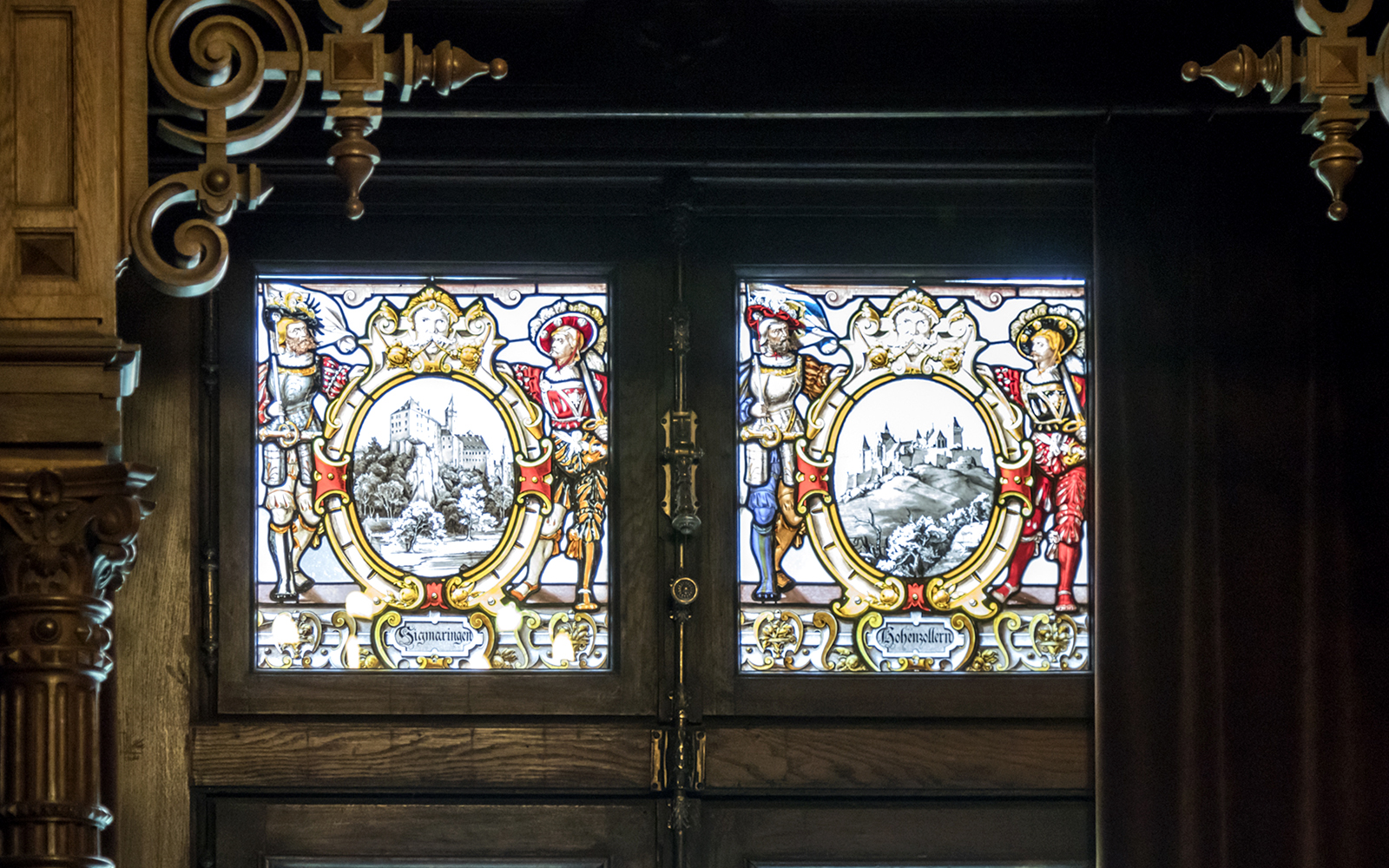 Stained glass windows depicting historical scenes inside Peles Castle, Sinaia.