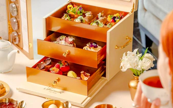 Afternoon tea set with pastries in a drawer at Fairmont Hotel.