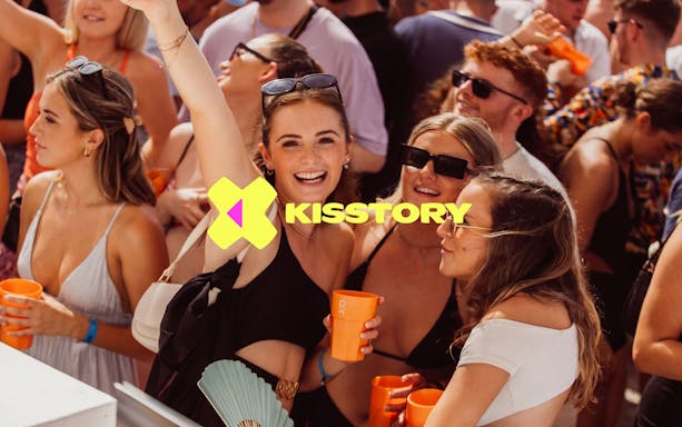 Partygoers enjoying Kisstory event at O Beach Ibiza with drinks and music.