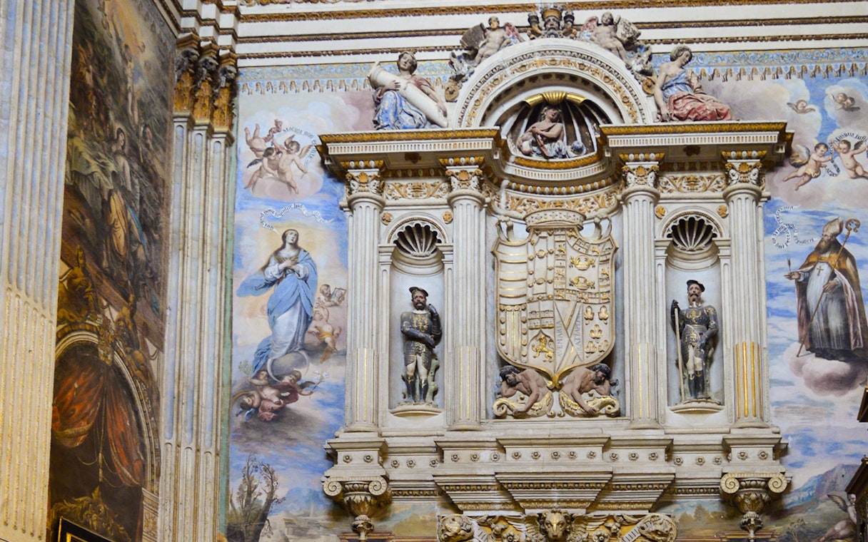 Royal Chapel of Granada interior with detailed frescoes and ornate sculptures, Spain.