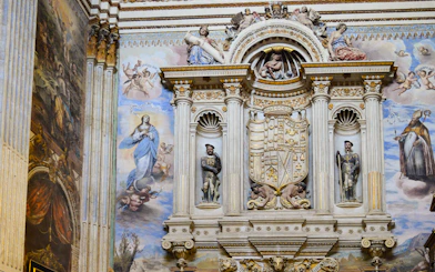 Royal Chapel of Granada interior with detailed frescoes and ornate sculptures, Spain.