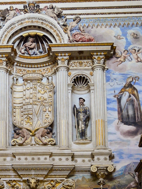 Royal Chapel of Granada interior with detailed frescoes and ornate sculptures, Spain.
