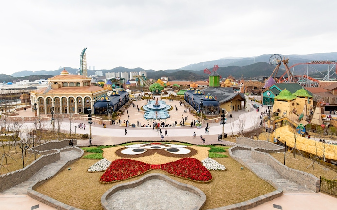 Lotte World Adventure Busan theme park with colorful buildings and a central fountain.
