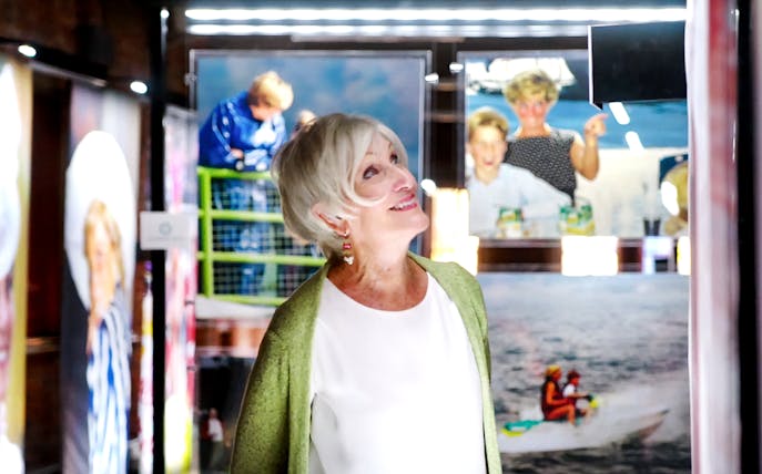 Visitor admiring Princess Diana photographs at Accredited Access Exhibition.