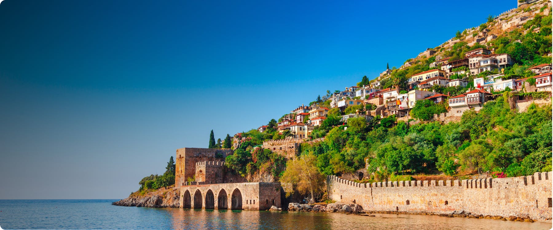 Historic harbor and hillside houses in Antalya, Turkey.