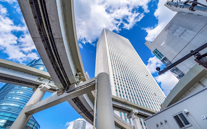 Sunshine 60 building in Ikebukuro with elevated highways and blue sky.
