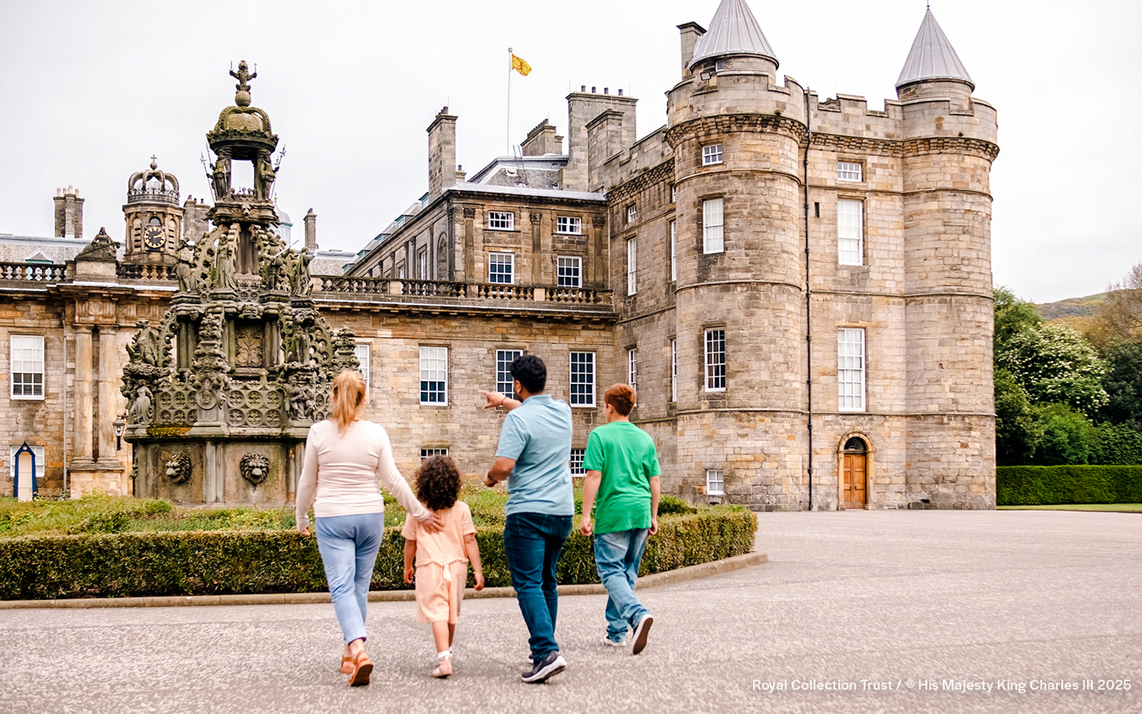 Visitors exploring the courtyard of the Palace of Holyroodhouse, Edinburgh.