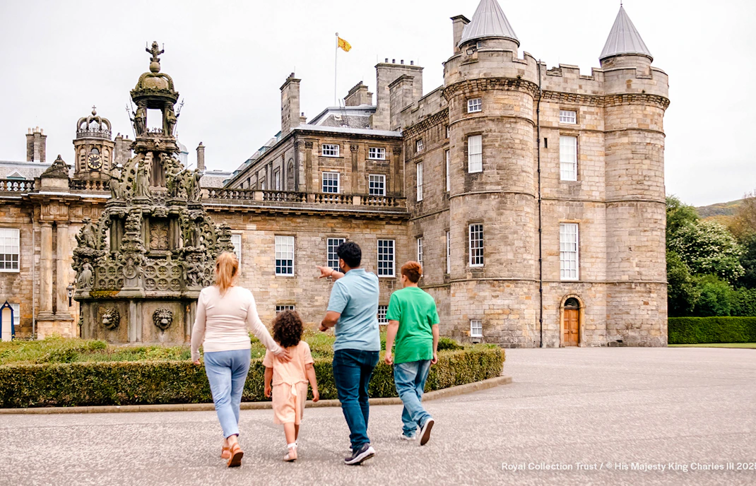 Visitors exploring the courtyard of the Palace of Holyroodhouse, Edinburgh.