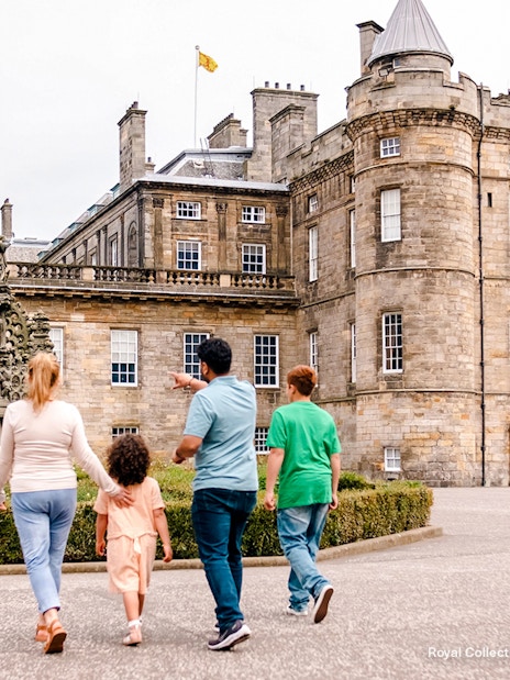 Visitors exploring the courtyard of the Palace of Holyroodhouse, Edinburgh.