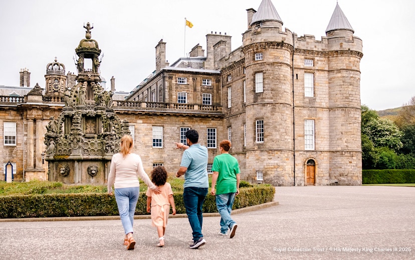 Visitors exploring the courtyard of the Palace of Holyroodhouse, Edinburgh.
