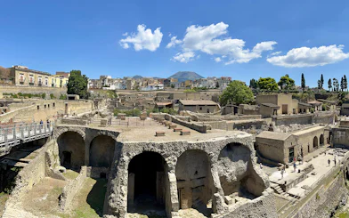 Ancient Roman ruins of Herculaneum with Mount Vesuvius in the background.