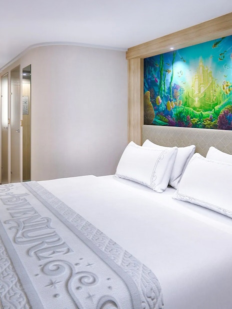 Deluxe Inside Stateroom with reef-themed decor on Disney Adventure Cruise.