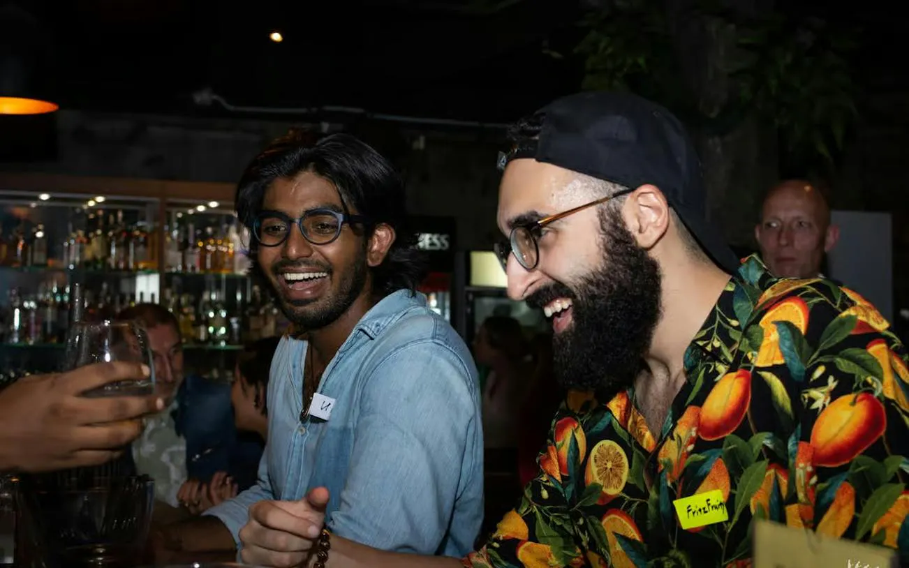 Friends enjoying drinks at a bar during a nightlife pub crawl in Dubai.