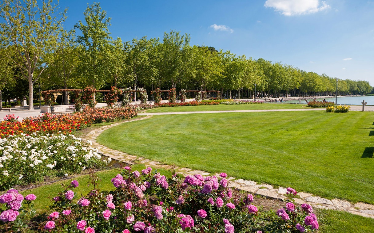 Promenade of Balatonfüred with colorful flower beds and a tree-lined path.