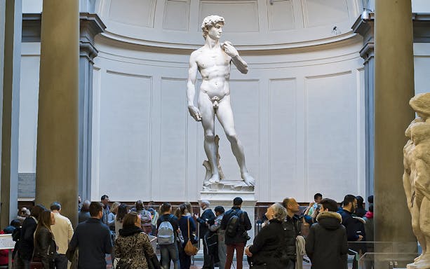 Visitors viewing Michelangelo's David at the Academia Gallery, Florence.
