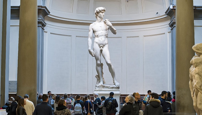 Visitors exploring art at Uffizi Gallery and Accademia Gallery in Florence, Italy.
