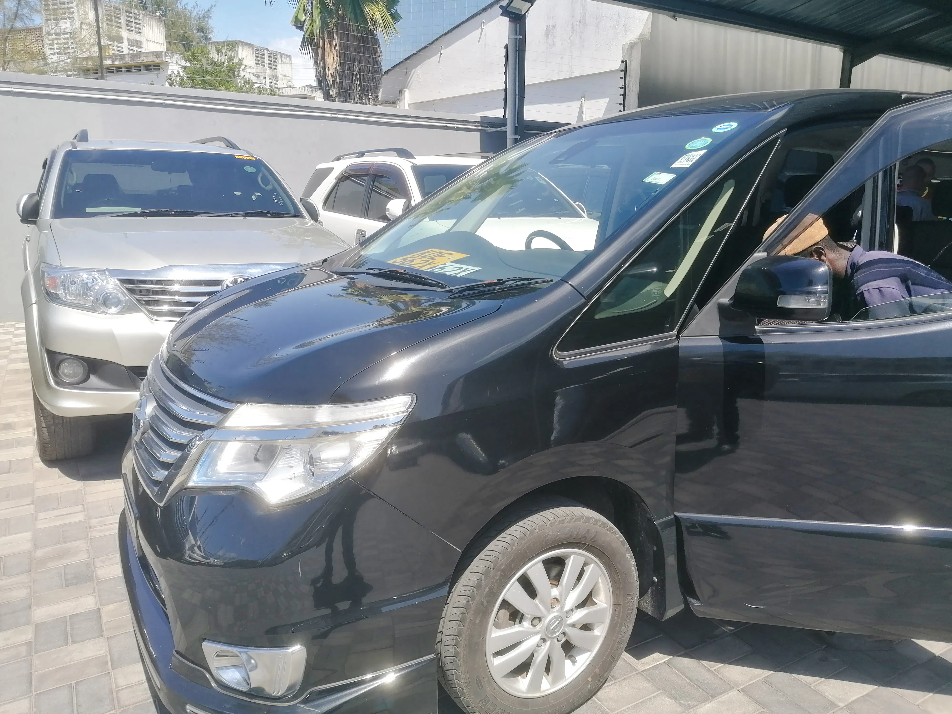 Minivan for Diani Beach transfer from Mombasa Airport, parked with driver inside.