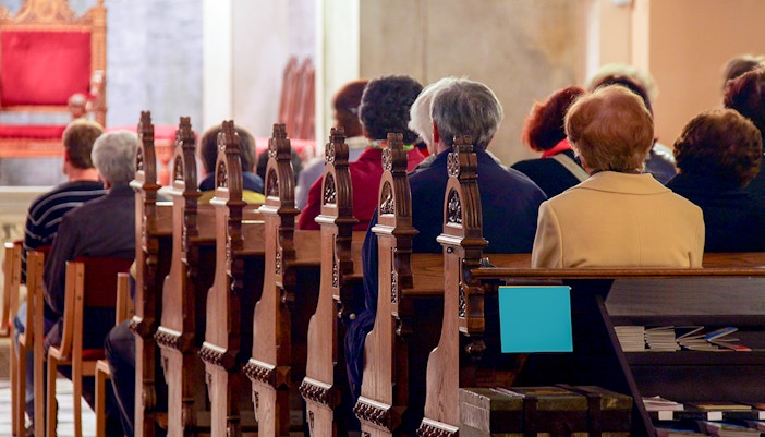 People attending Mass in Church