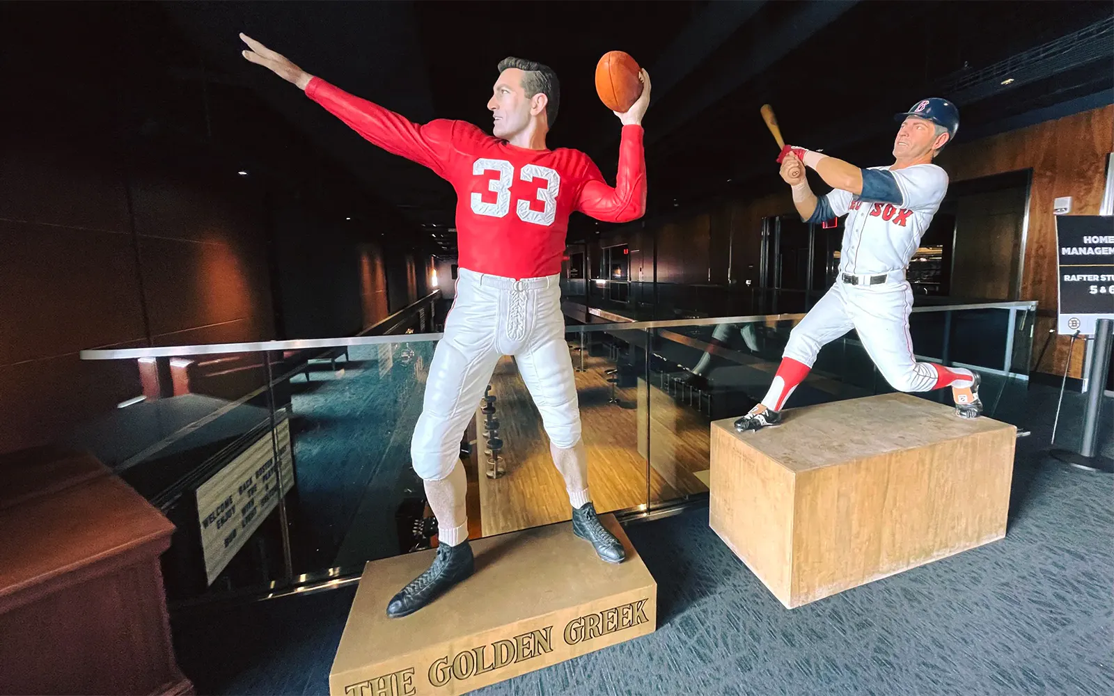 Statues of a football player and baseball player inside The Sports Museum, Boston.